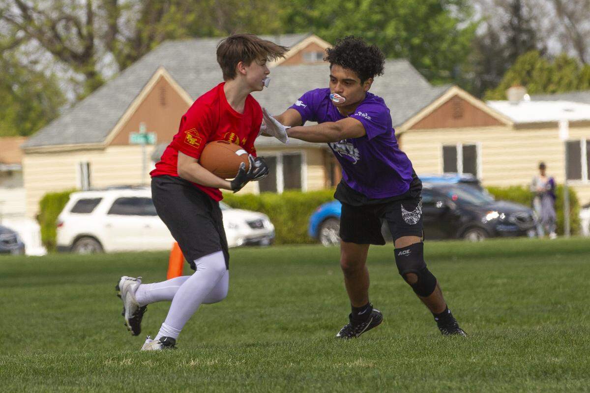 Young football players play 7on7 with the Columbia Basin Youth Football 7on7 Passing League. They are learning the sport by running football pass patterns, defending passes and throwing them to each other near Eastgate Elementary School in Kennewick.