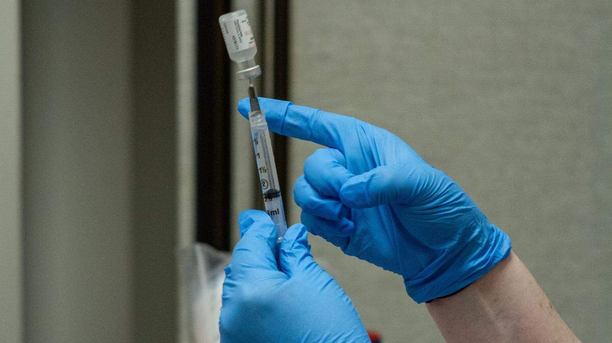 A medical staffer prepares COVID-19 vaccine doses to administer at a vaccine clinic in Richland.
