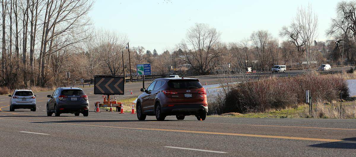 Eastbound traffic on Van Giesen Street, also known as Highway 224, is temporarily limited to one lane Wednesday morning because floodwaters are still partially covering the outer lane of the roadway in Richland.