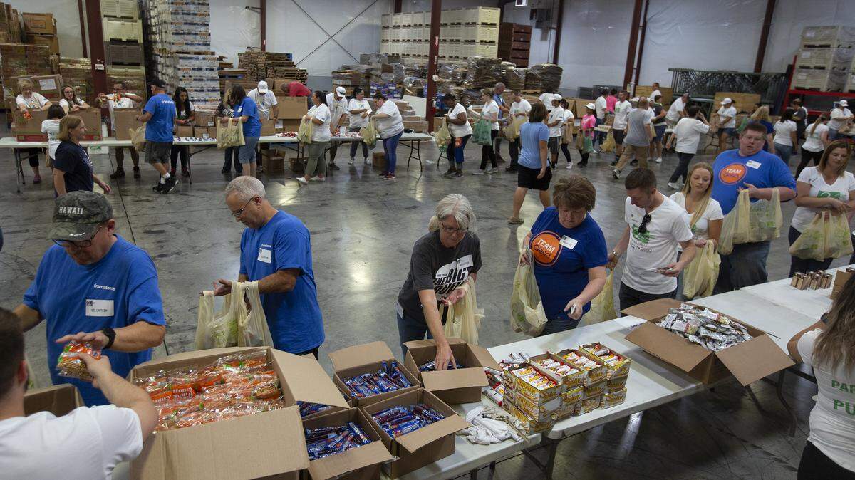 About 120 volunteers gather inside Second Harvest in Pasco to put together 6,100 “Bite2Go” kits Friday during one of its big volunteer days. Bite2Go is a 2nd Harvest program that gives weekend food supplies to Tri-City kids in need during the school year. To sponsor a child or make a donation, go to www.2-harvest.org/Bite2Go