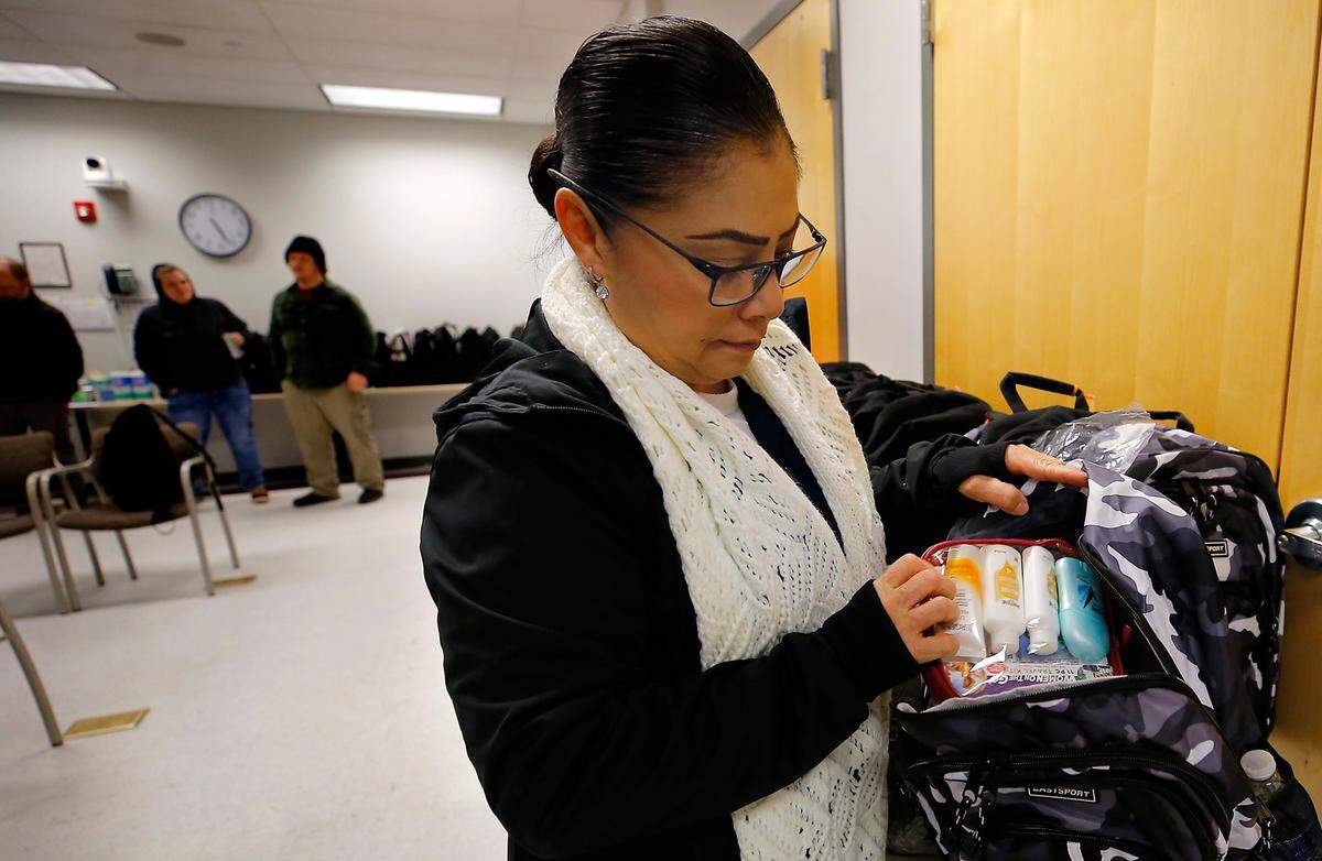 Niria Lucatero, Benton County Housing Program Navigator & Veterans Program Specialist, shows some the supplies in the backpacks to be handed out during the annual Point in Time homeless count in the Tri-Cities. About 30 people turned out to help with the count.