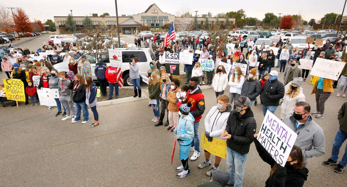 Several hundred students, parents and teachers gather in the Kennewick School District administration building parking lot for a rally to open schools for in-person learning following the school board’s recent decision to delay re-opening middle and high schools until February.