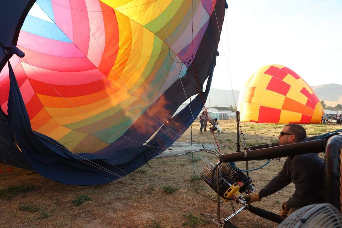 Pilot Devin White fills his hot air balloon Spectra at the Great Prosser Balloon Rally Friday.