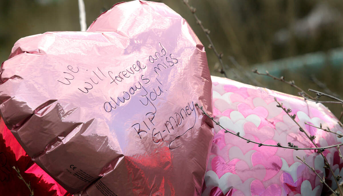 A memorial, including balloons, flowers and candles, has been created near the site where Gordon Whitaker, 45, was shot and killed by a Kennewick police officer.