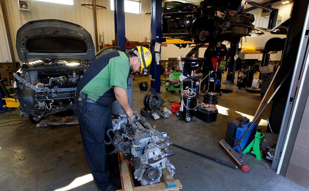 Employee Victor Maldonado removes a used engine and other components at the new location of U-Pull-It and Supreme Truck and Auto Parts.