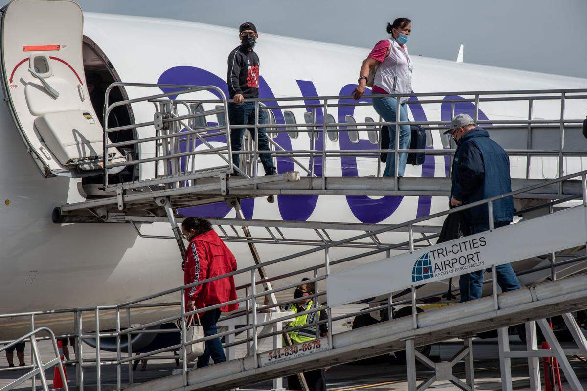 Passengers from the first Avelo Airlines flight into Pasco deplane at the Tri-Cities Airport on Thursday. The newest airline to launch in the U.S. in 15 years will have nonstop flights between Hollywood Burbank and the Tri-Cities several days a week.