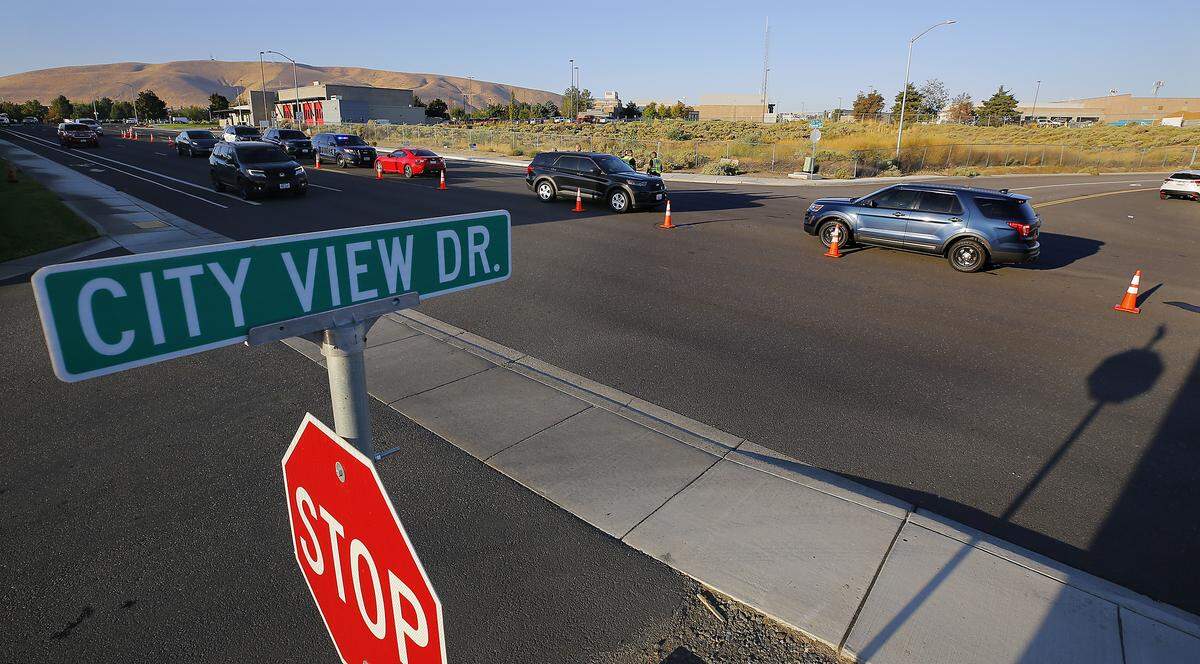 Richland police officers investigate the early Wednesday morning fatal collision involving a bicyclist and a car on Duportail Street at City View Drive. 