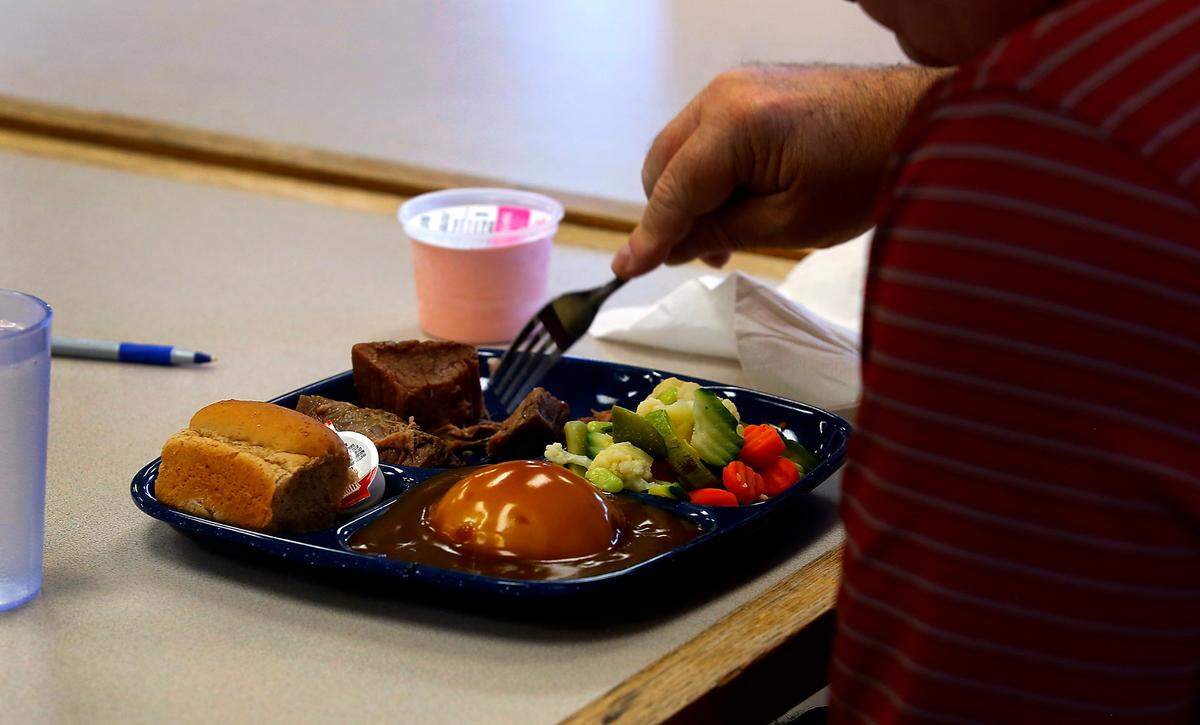 A Tri-City senior enjoys a hot roast beef meal at the Mid-Columbia Meals on Wheel cafe in Richland. The cafe, at 1824 Fowler Street, is now is serving meals at more times, including afternoon hours four days a week and breakfast hours on Wednesday.