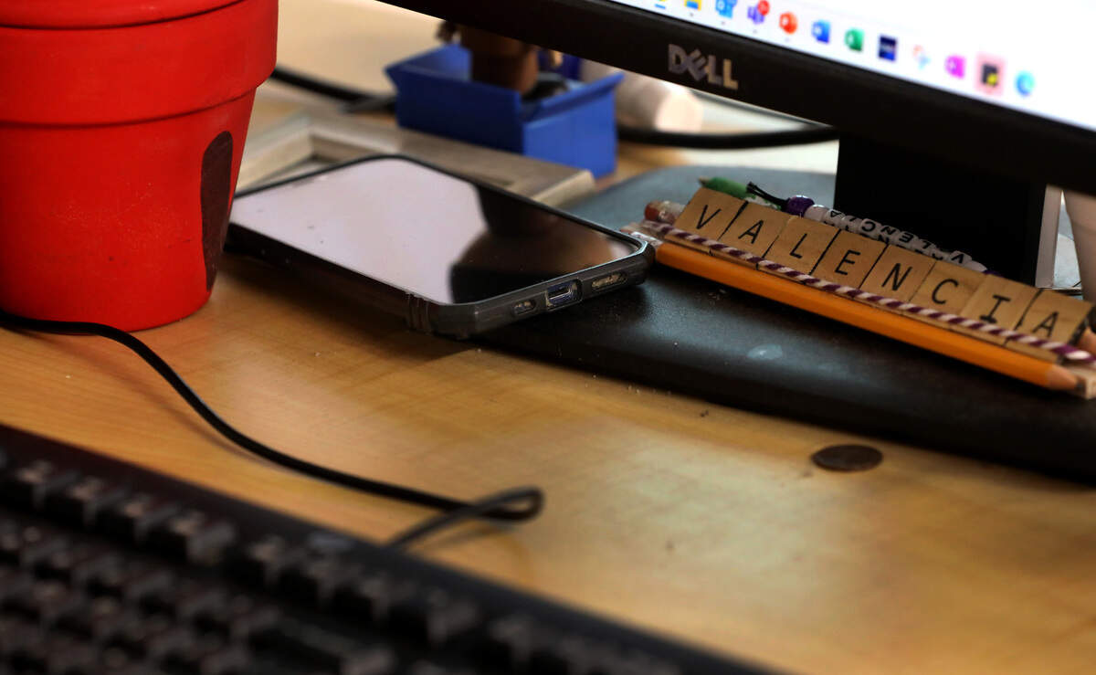 The smartphone belonging to Pasco High teacher Fabian Mendoza Valencia intentionally sits on his desk while he teaches a class. He and other educators are leading by example when it comes to new restrictions on cellphone use in the classroom.
