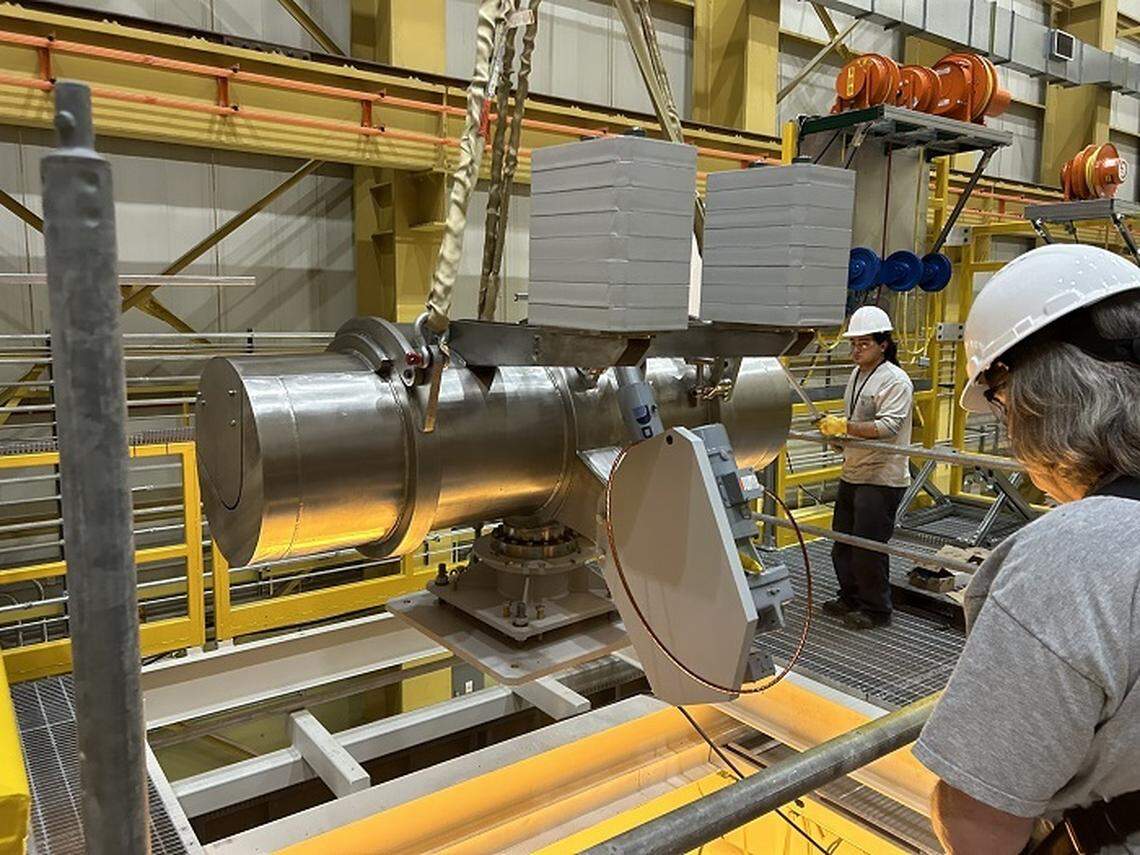 Workers install components for a mock-up at the Hanford Site’s Maintenance and Storage Facility. A full-scale mock-up was built to allow workers to test equipment and practice processes before starting to move nearly 2,000 radioactive capsules from an underwater basin to interim dry storage.