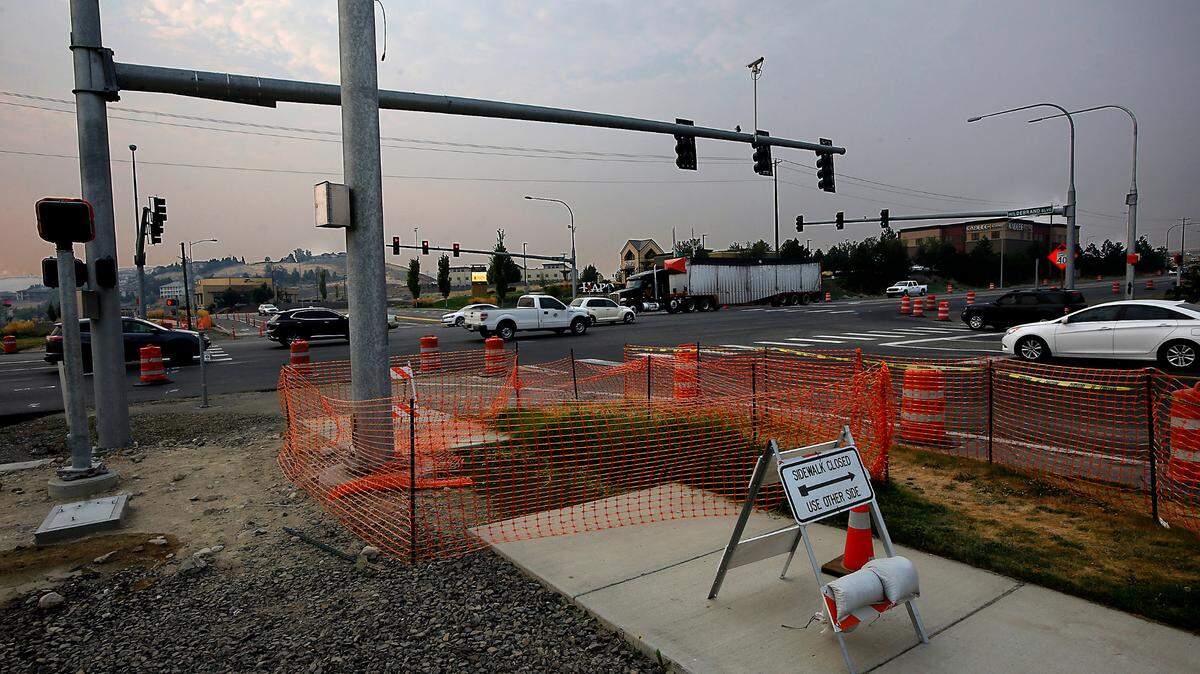 Early morning commuters drive past traffic control barrels and construction signs on Highway 395 at Hildebrand Boulevard in Kennewick. Work on the traffic signals is beginning each night at 8 p.m and ending at 6 a.m. Friday, Sept. 16. Expect congestion and four-way flaggers in the construction zone. 