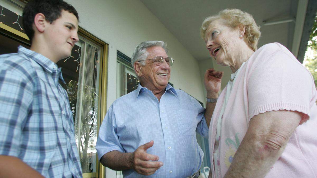 Bob Ferguson, center, of Richland, talks to his wife, Katie, and a grandson before receiving the Sam Volpentest Leadership Award in 2005.