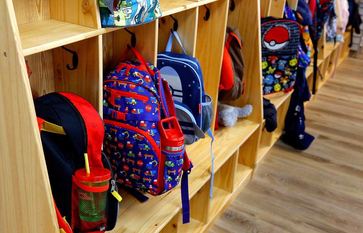 Backpacks hang on a wall cubby at Level Up Learning preschool in Kennewick.