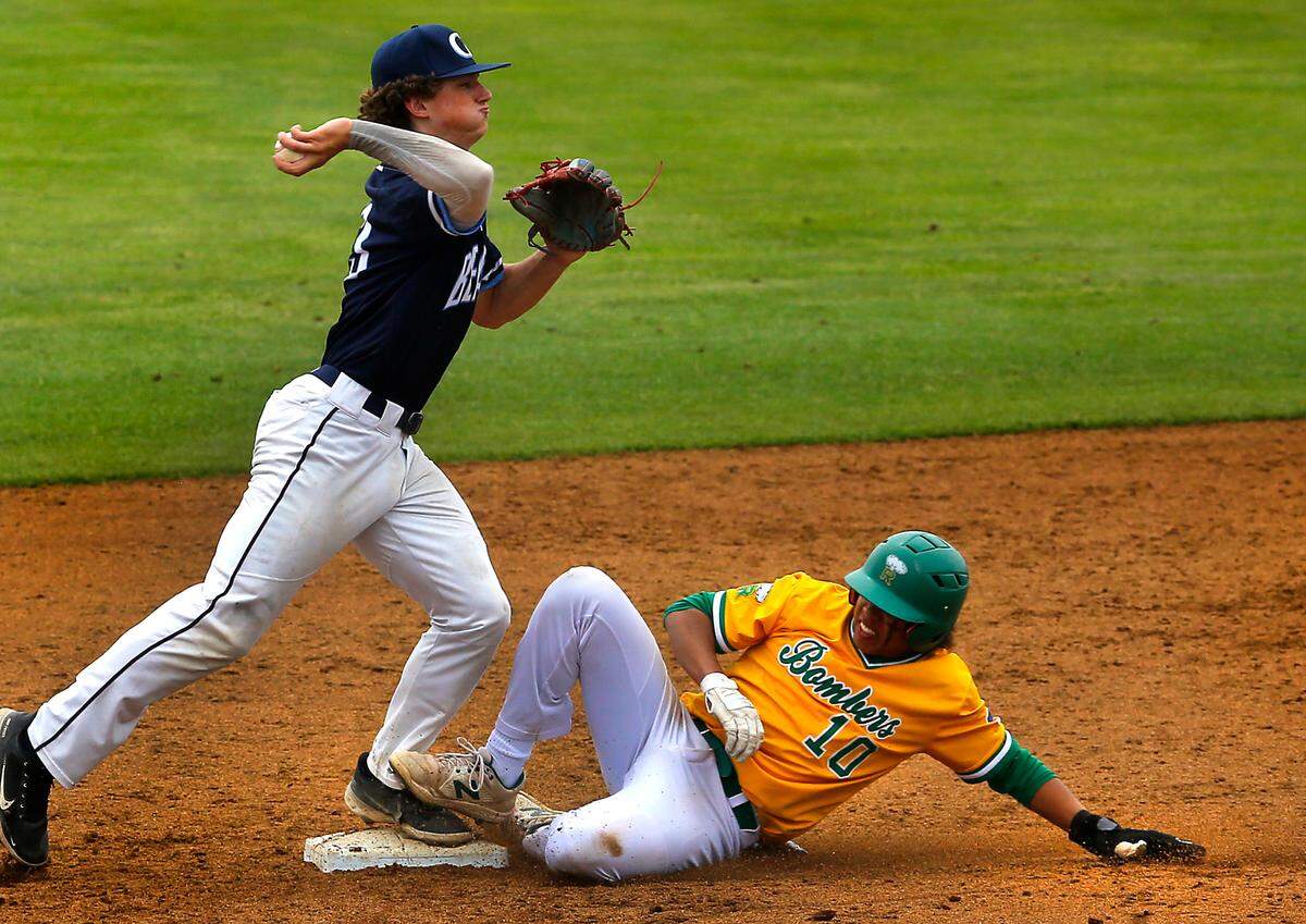 Richland base runner Chris Daniels (10) slides into second base to break up a double-play throw by Olympia’s Logan Shepherd during Friday’s state 4A playoff game in Pasco.