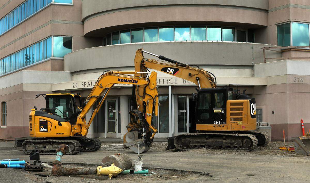 Heavy equipment sits outside entrance of the former Kennewick General Hospital campus as construction crews work on gutting the first floor of the facility.