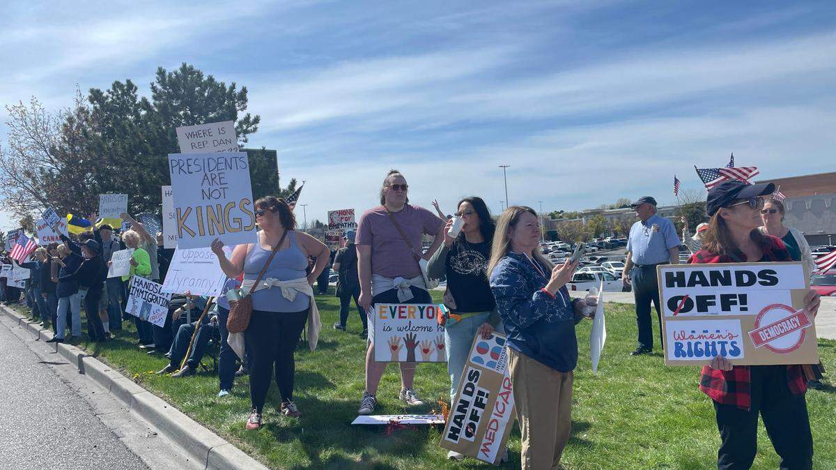 Hundreds lined Columbia Center Boulevard in Kennewick on Saturday for a “Hands Off! Kennewick Fights Back,” to protest Trump administration policies.