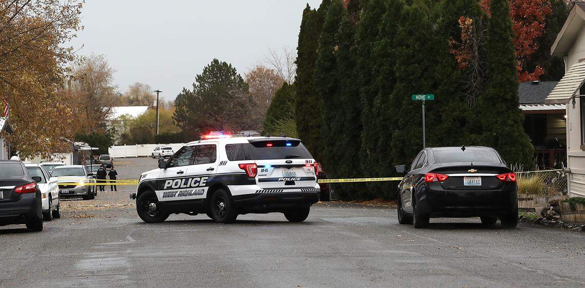 A West Richland Police Department patrol car blocks the roadway at the scene of Monday’s early morning drive-by shooting.