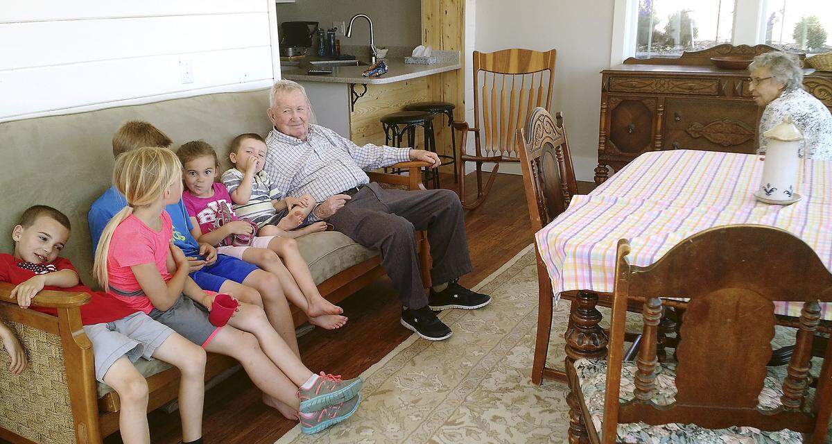 George and Jeanne Jenkins visit with their great-grandkids on an earlier date in their Richland apartment. George Jenkins celebrated his 100th birthday on March 27.