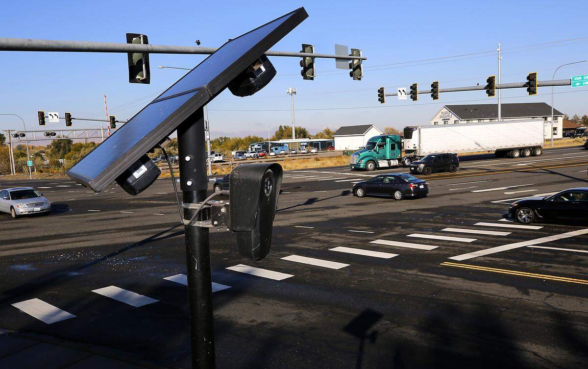 Traffic streams past a solar-powered license plate reading camera attached to a pole at West Van Giesen Street and Highway 240 in Richland.