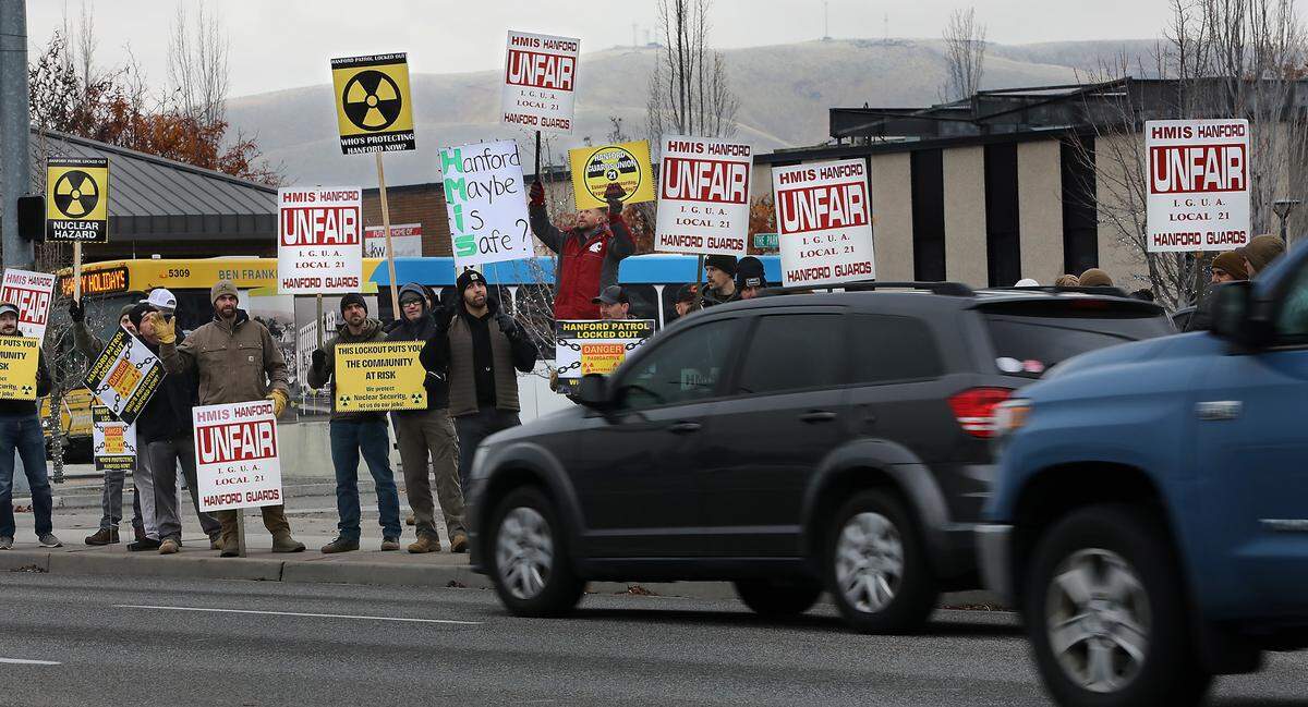 Members of the Hanford Guards Union Local 21 picket on Dec. 11, 2024, near John Dam Plaza in Richland after their contract expired and they were locked out of work.