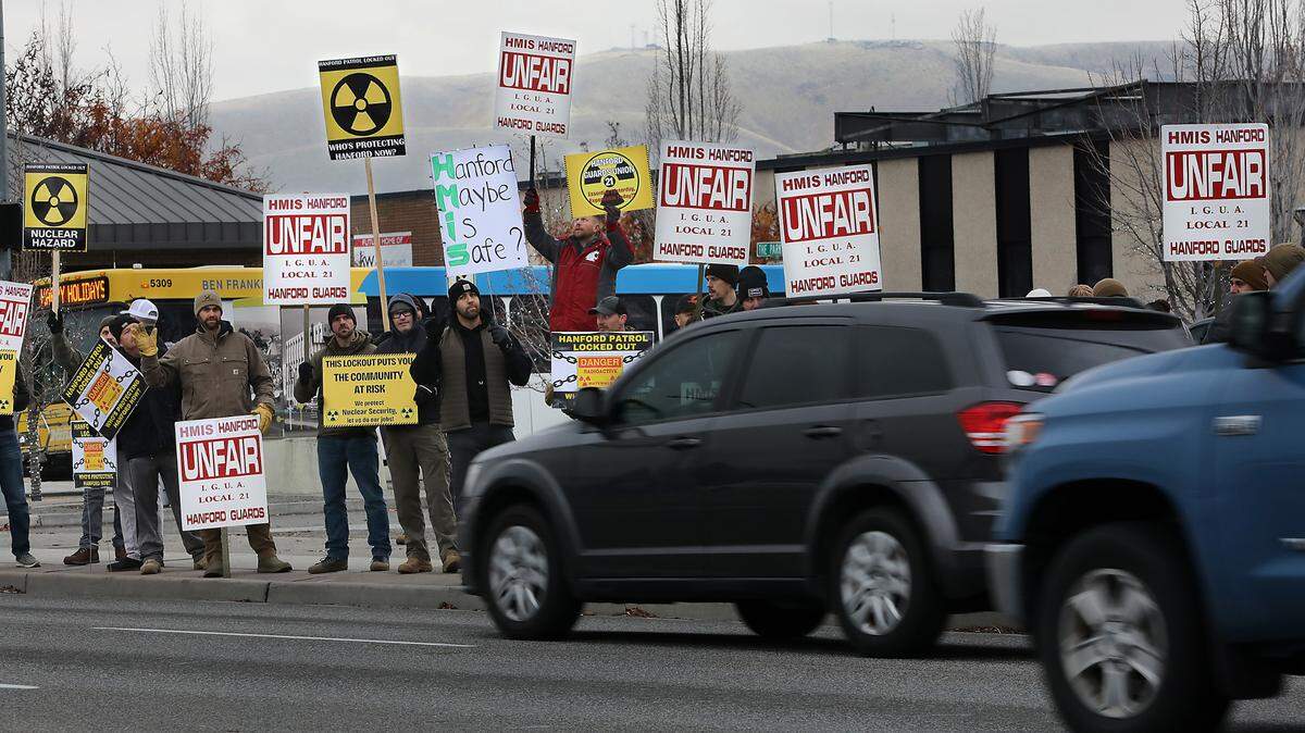 Members of the Hanford Guards Union Local 21 picket on Dec. 11, 2024, near John Dam Plaza in Richland after their contract expired and they were locked out of work.