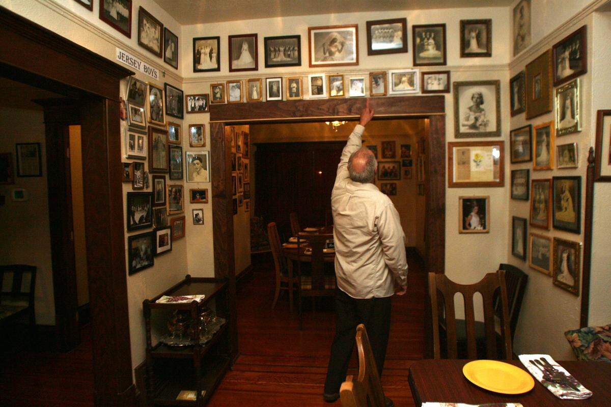 Carmine Aitoro was happy to tell stories related to the hundreds of family photographs hanging on the wall of his Italian restaurant in Kennewick.