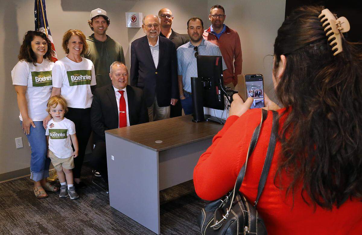 Matt Boehnke is surrounded by family and supporters while posing for a photo being taken by his campaign manager Emily Garza on Monday.