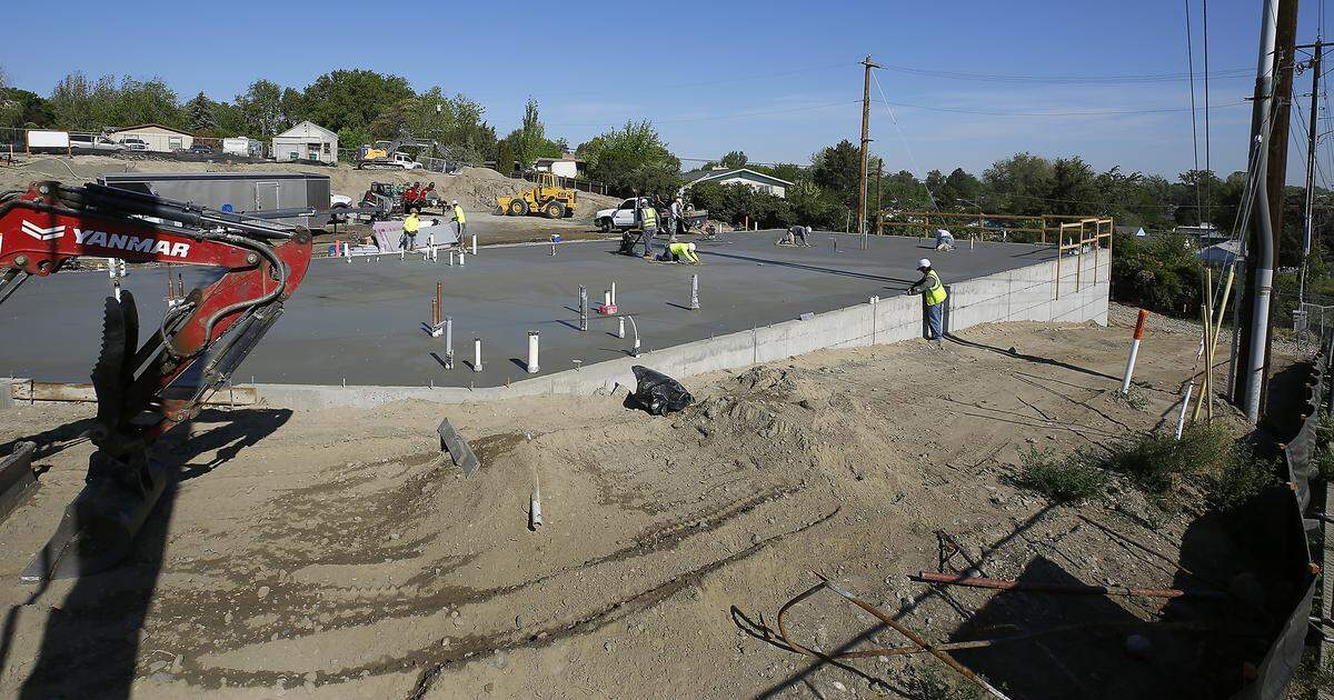 Concrete finishers work on a Metro Mart gas station, convenience store and laundromat at 1400 W. 10th Ave. in Kennewick. 