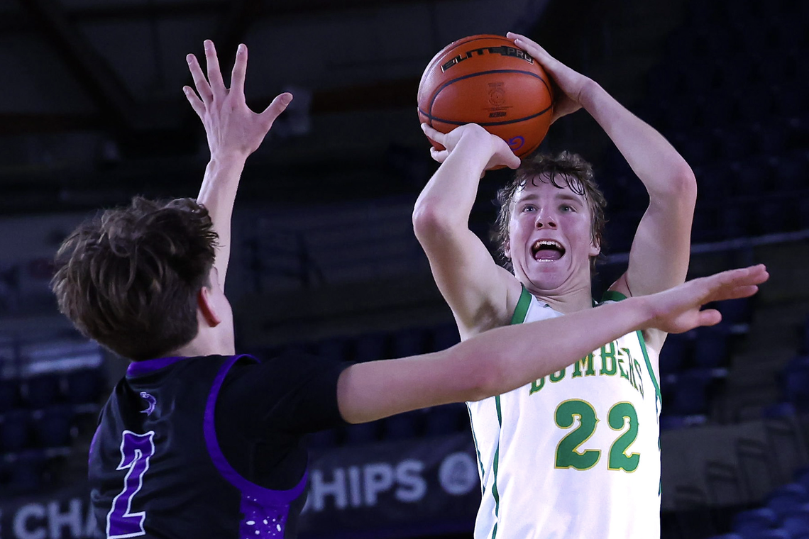 Richland junior Jackson Woodard (22) shoots over Lake Washington’s Hunter Phipps (2) during the WIAA Class 4A boys state basketball semifinals Friday, March 6, 2026, at the Tacoma Dome in Tacoma. Woodard scored a game-high 30 points and made seven three-point shots as Richland defeated Lake Washington 83-70 to advance to the state championship game.