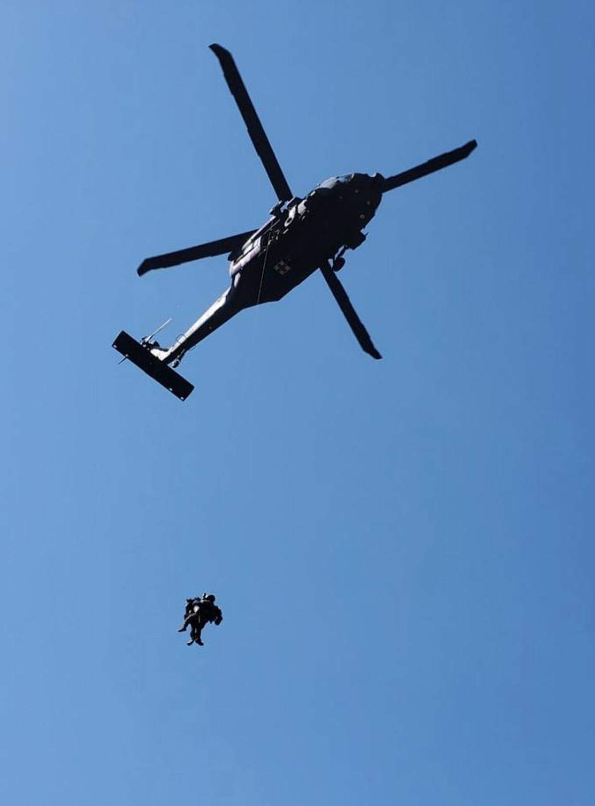 An Oregon Army National Guard Black Hawk was used to rescue two men and recover the body of a third after they fell off a ledge while hiking in the forest south of Pilot Rock, Ore.