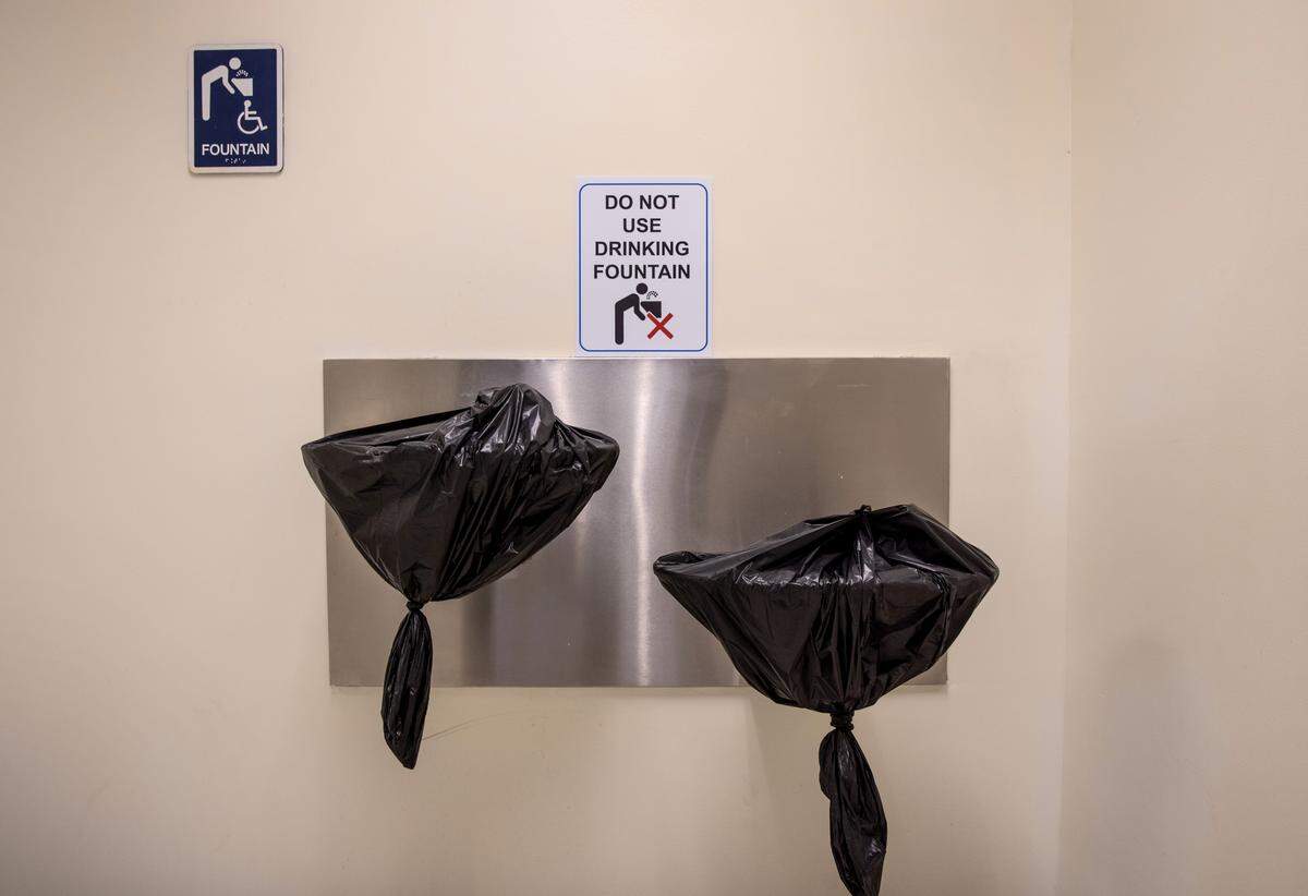 STAMFORD, CONNECTICUT - MARCH 10: Water fountains hang covered, due to pandemic protocols, in a school corridor on the first day of in-person learning for five days per week at Stark Elementary School on March 10, 2021 in Stamford, Connecticut. Stamford Public Schools, like many school districts nationwide, are returning to full time in-school learning as pandemic restrictions begin to ease. The district had been operating on a hybrid model for most of the school year. (Photo by John Moore/Getty Images)