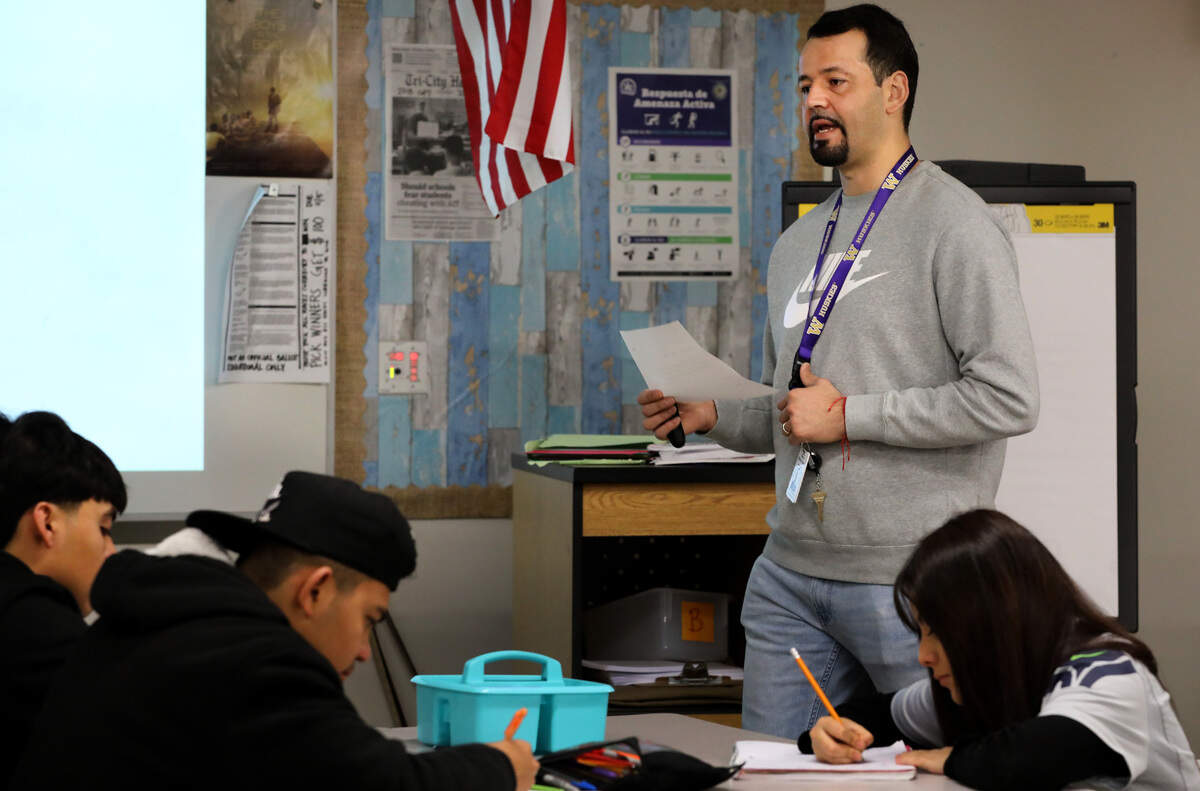 Fabian Mendoza Valencia, a English language development teacher at Pasco High School, works in the classroom with students.