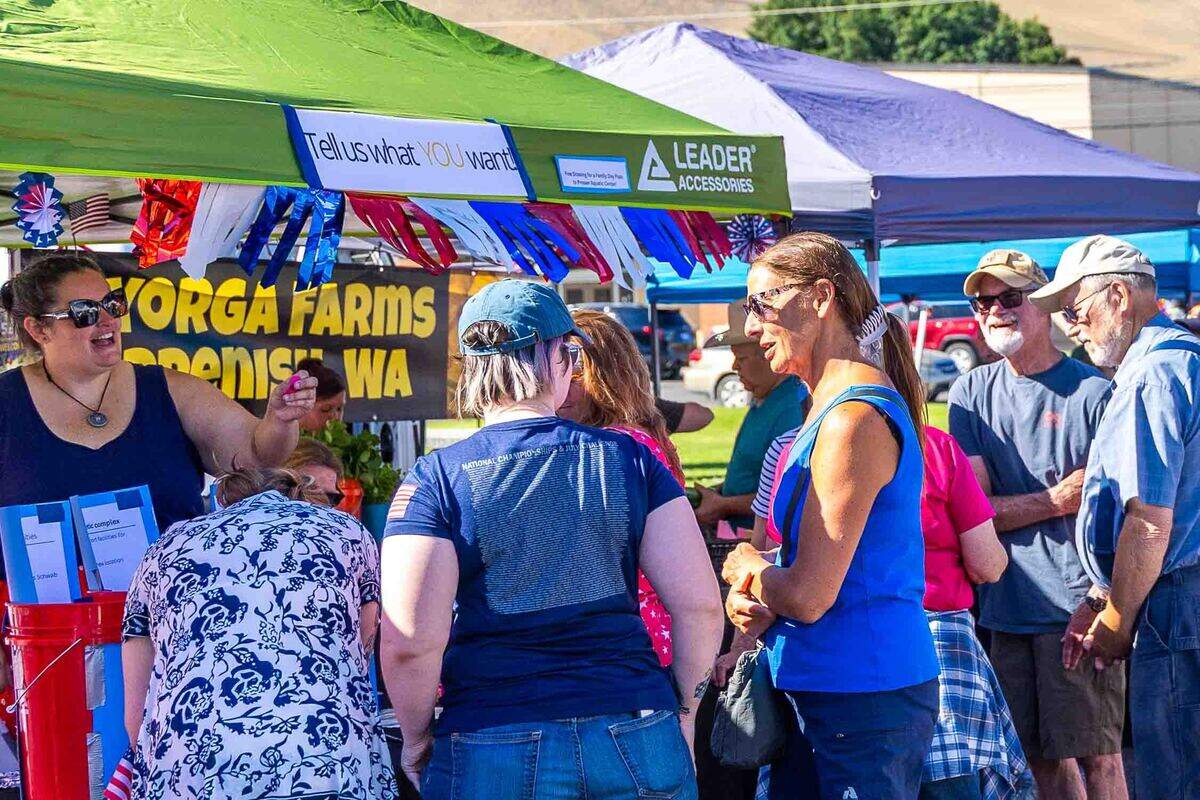 Visitors browse vendor booths Saturday at the Prosser Farmers Market during Prosser’s Old-Fashioned Fourth of July celebration. Hundreds of residents and visitors attended the holiday market, classic car show and other community festivities throughout the day.