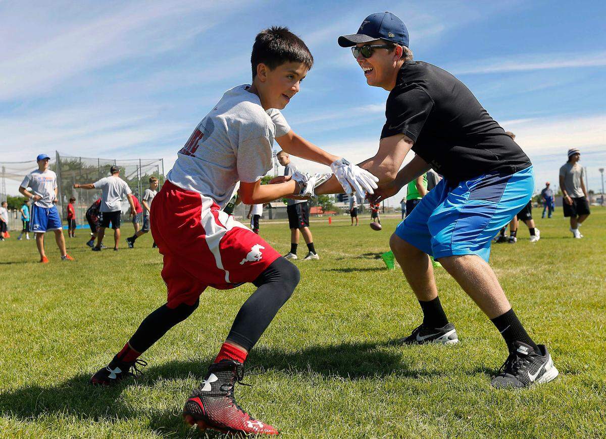 Kellen Moore, right, who grew up in Prosser, squares off against Brock Weimann, 13, of Prosser, during the 2016 Kellen Moore Passing Camp in Richland. Kellen and his father Tom hosted the annual camp to work with area kids on football techniques. Kellen Moore is the new head coach of the New Orleans Saints.