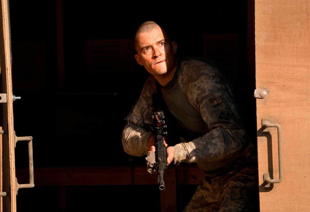 This image released by Screen Media shows Orlando Bloom in a scene from “The Outpost.” The film tells the story of the heroic Battle of Kamdesh in Afghanistan in 2009, where the Taliban attacked a remote American Combat Outpost that was nearly impossible to defend.