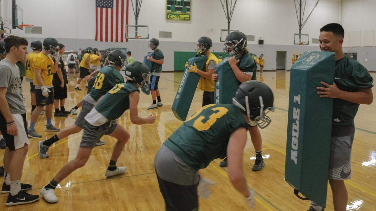 Defending 4A state champion Richland started football practice Wednesday morning. The Bombers, as well as the other Mid-Columbia football teams, were forced to practice inside because of the poor air quality outside.