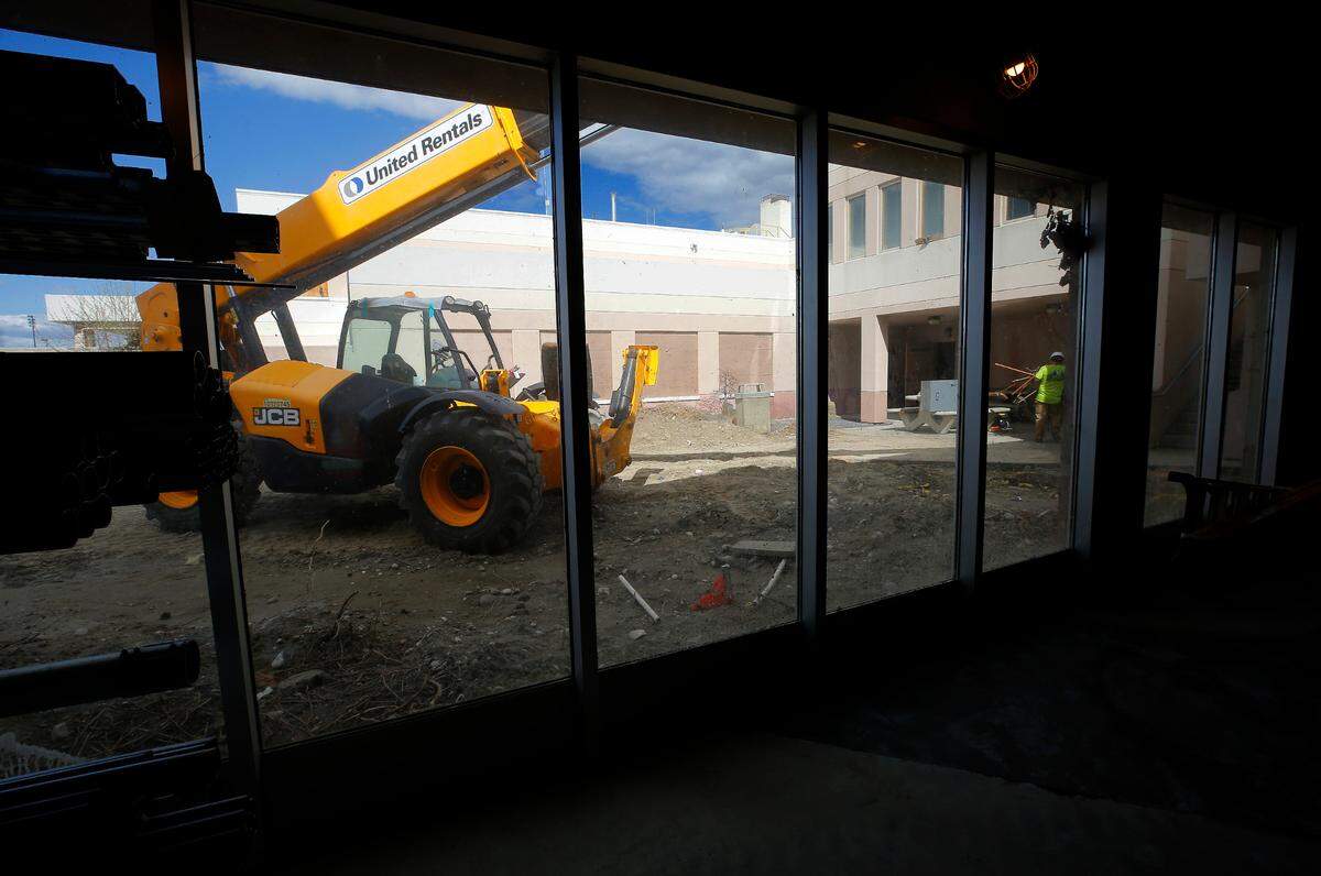 Heavy equipment sits outside the former Kennewick General Hospital campus as construction crews work on gutting the first floor of the facility. The building renovation for the new Columbia Valley Center for Recovery facility is being designed and constructed by Bouten Construction and NAC Architecture.