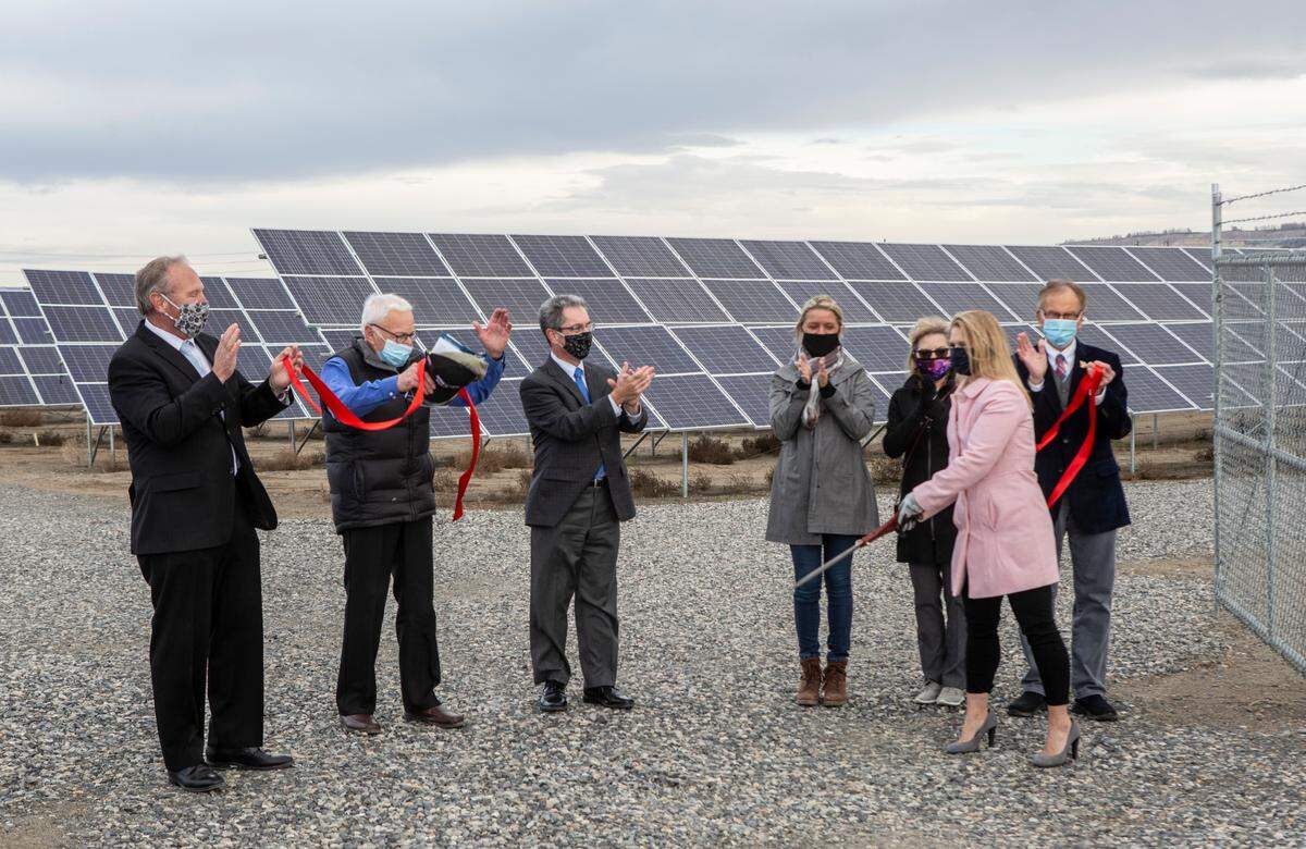 Aimee Gerkensmeyer, wife of the late project manager Clint Gerkensmeyer, cuts the ceremonial ribbon Tuesday morning to unveil more than 11,000 new solar panels. They will provide enough electricity for about 600 Richland homes as part of the Horn Rapids Solar, Storage and Training Project headed by Energy Northwest and project partners Tucci Energy Services, the city of Richland, Potelco Inc., the state Department of Commerce and Pacific Northwest National Laboratory.