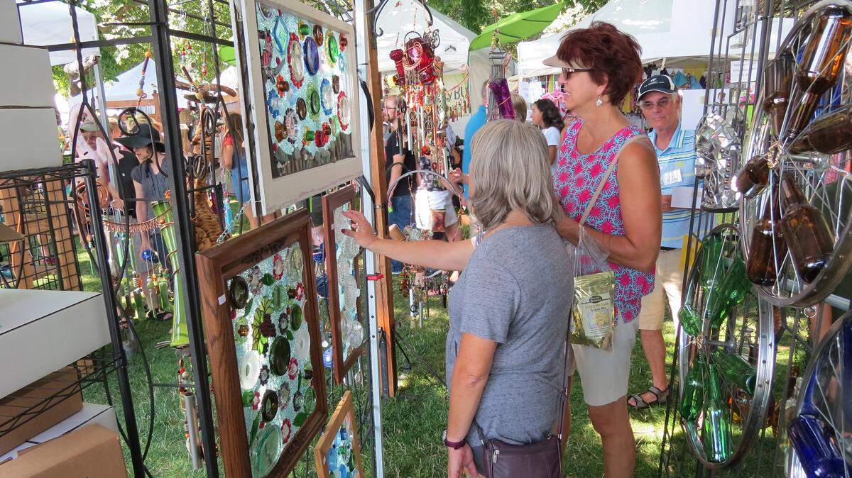 Customers browse Friday at the 68th annual Art in the Park at Howard Amon Park in Richland. The free event, which draws vendors from across the country, continues Saturday from 9 a.m. to 8 p.m.