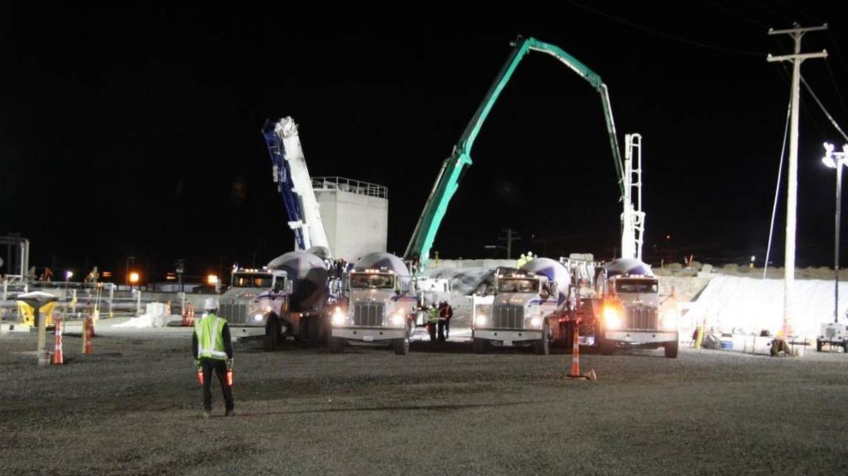 Cement trucks deliver grout to a pumper truck to pour into the top of a partially collapsed waste storage tunnel at the Hanford nuclear reservation last fall. The work was done under emergency authorization and now Hanford officials want to fill a second tunnel to prevent it from failing.