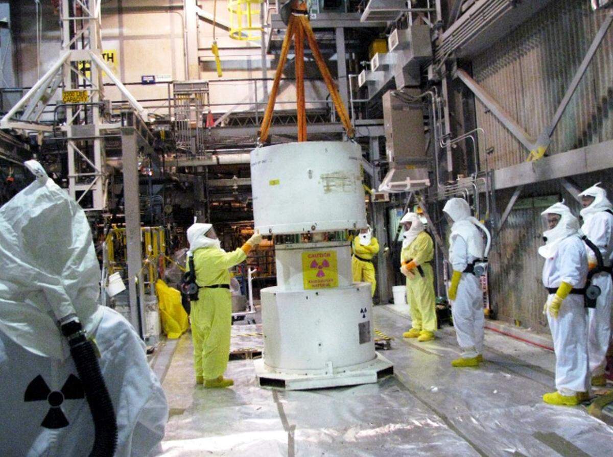 Hanford workers take apart a cask in the transfer bay at Hanford’s K West Basin, which is about 400 yards from the Columbia River, as work started in 2009 to deal with radioactive sludge. The cask was used to ship samples to Pacific Northwest National Laboratory for characterization.