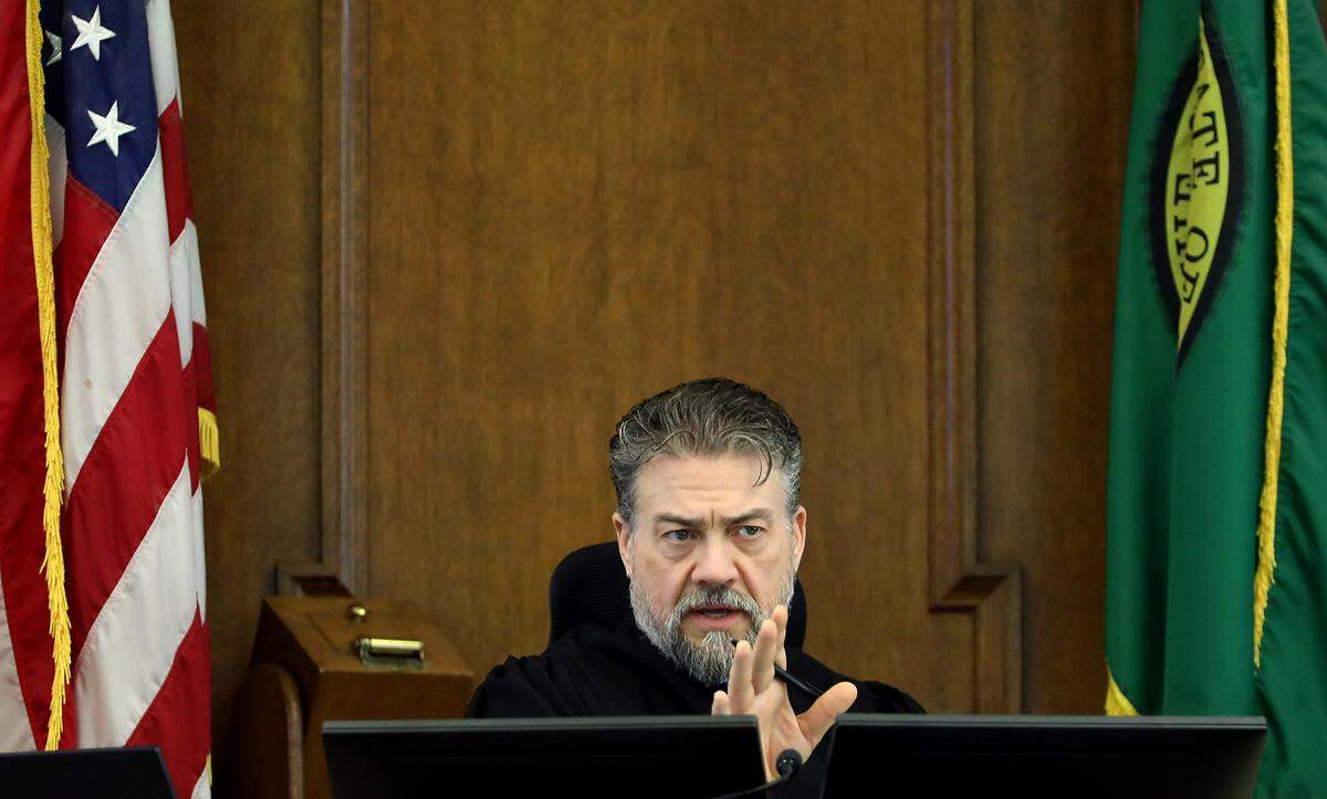 Superior Court Judge Brandon Johnson listens to Benton County attorney Andrew Cooley, left, and plaintiff attorney Eron Cannon in the Walla Walla courtroom. 