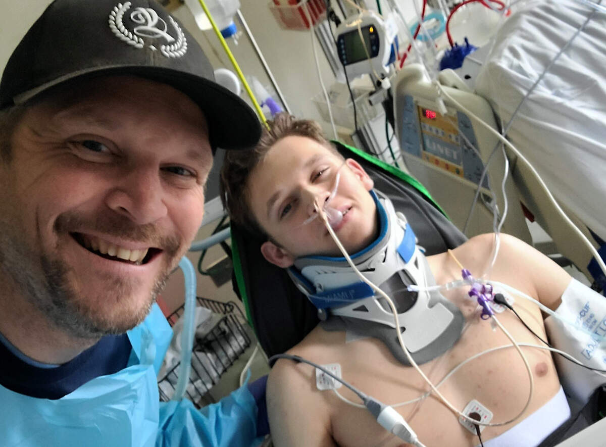 David Sample broke his C6 vertebra April 23 when he landed awkwardly on his neck after a flip on a trampoline. He faces a long rehabilitation, but his family is encouraged that he has regained some movement in his hands. He shown in a Seattle area hospital with his father, Ray Sample, of Richland.