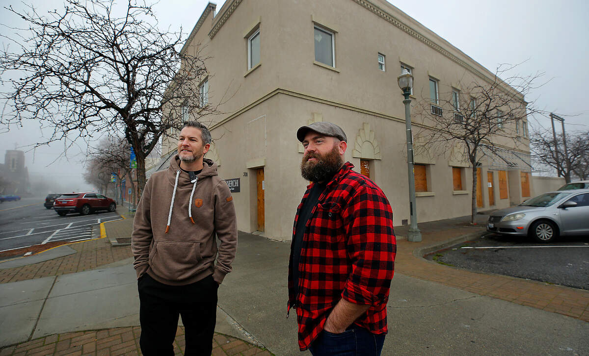 Kellen Adcock, left, and Kagen Cox bought the fire-damaged Cascade Building at 304 W. Kennewick Ave., the same month Cox opened Kagen’s Coffee & Crepes next door.