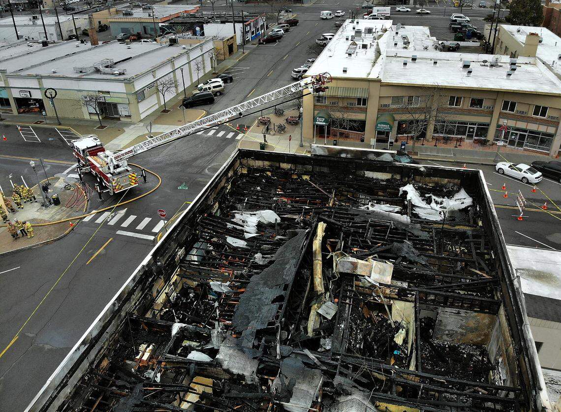 A Kennewick fire department ladder truck stayed on the scene into the afternoon of last Friday’s two-alarm fire in a historic downtown building at the corner of Kennewick Avenue and Cascade Street that damaged businesses and burned apartments. One person was taken to the hospital.