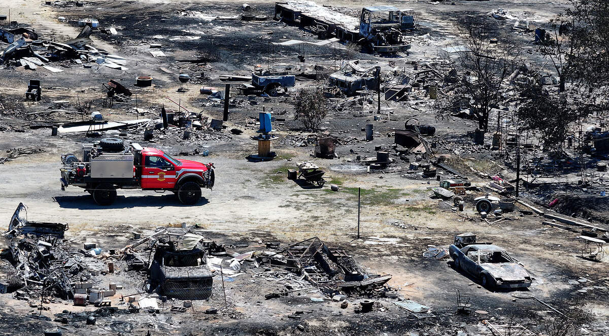 A brush fire truck sits at the property at 61901 Old Inland Empire Highway where fire officials say a home was consumed by Sunday's 820-acre wildfire.
