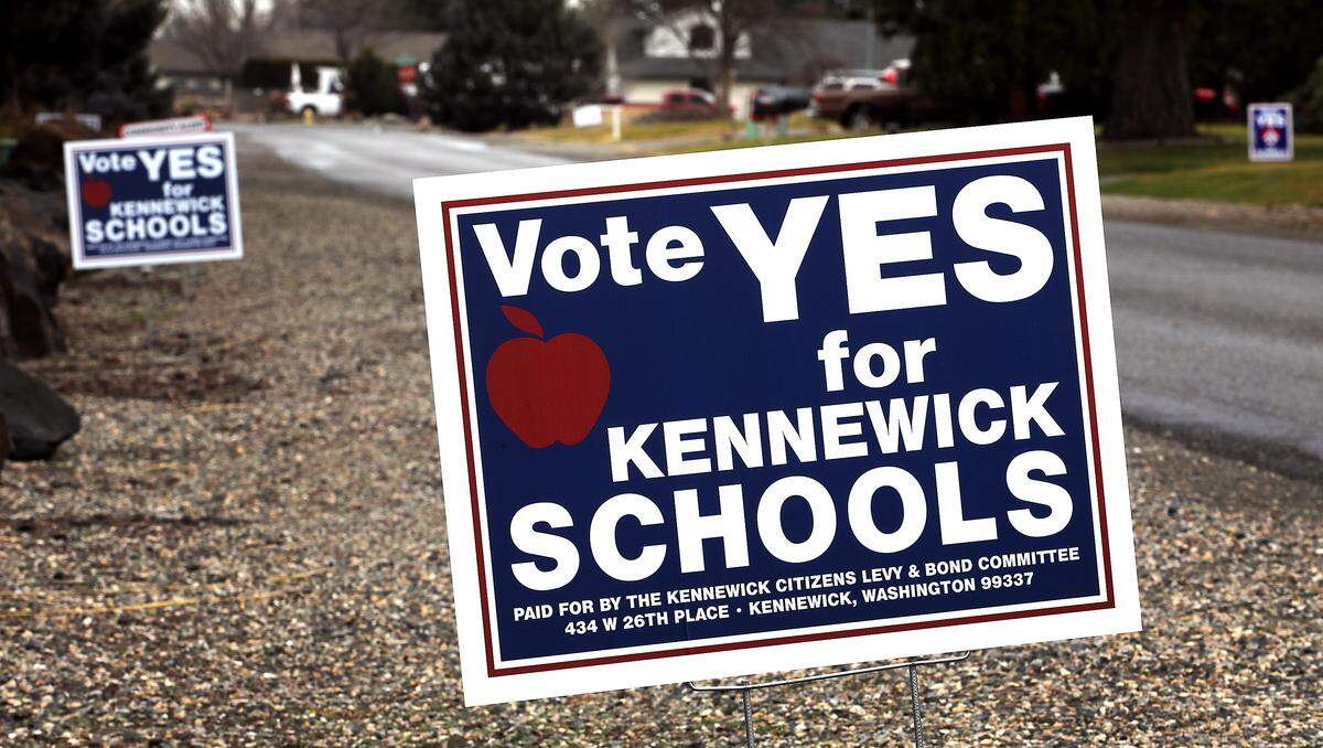 Campaign signs showing support for the Kennewick School District's levies on the ballot for next week's special election are displayed in a couple of yards in a central Kennewick neighborhood.