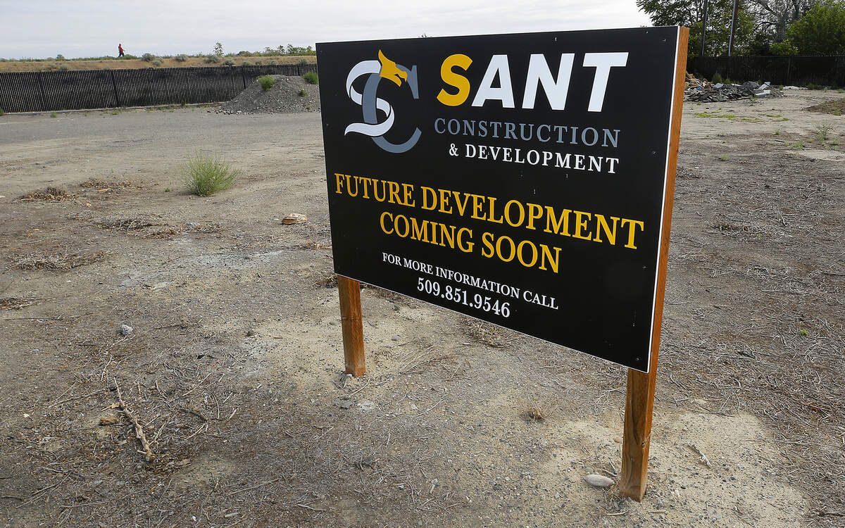 A sign has been posted near the downtown Kennewick Mister Car Wash site for a project with up to 12 townhomes at 627 N. Everett St. in downtown Kennewick.