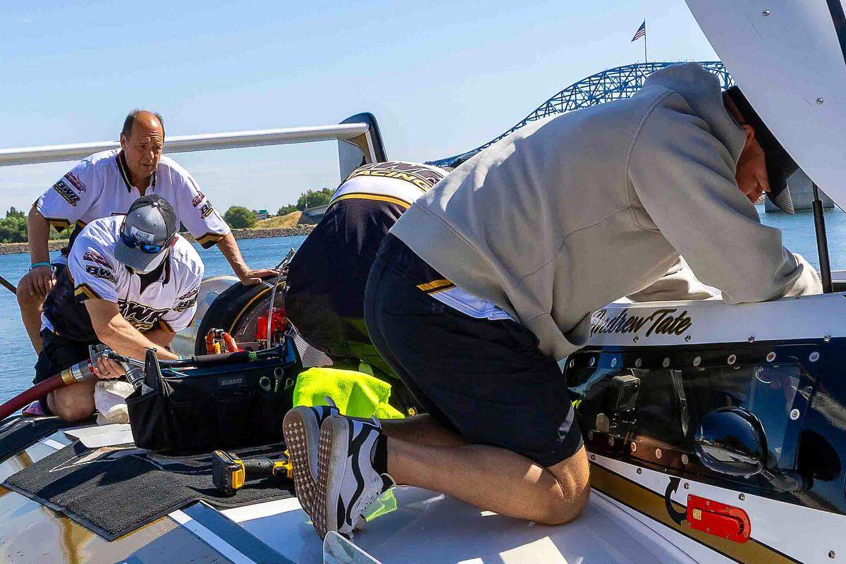 Crew members work atop the U-91 Miss Goodman Real Estate hydroplane after defending national champion driver Andrew Tate returned from a test run Saturday on the Columbia River in Kennewick.