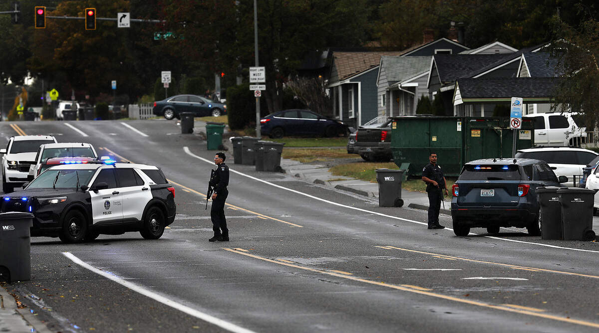 Kennewick police officers block off West Fourth Avenue Wednesday afternoon in Kennewick while searching for a pair of suspects wanted in connection with a pair of robberies earlier this month, Commander Aaron Clem said. A group of Kennewick officers and Benton County deputies spotted the suspects near Fourth Avenue when a foot chase started. Both were apprehended in the vicinity.